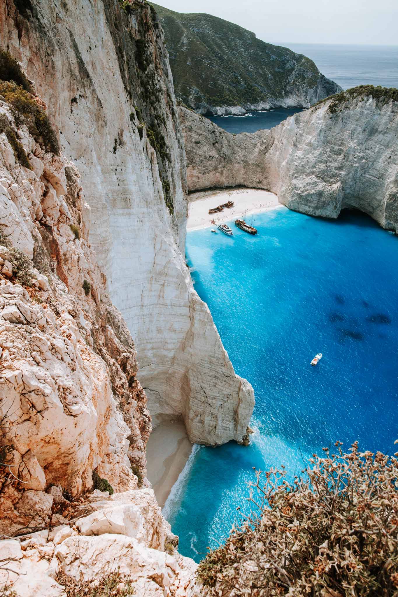Shipwrecked by Will Salkeld, colour photograph of Navagio Beach Zakynthos with white limestone cliffs and a shipwreck on the sand
