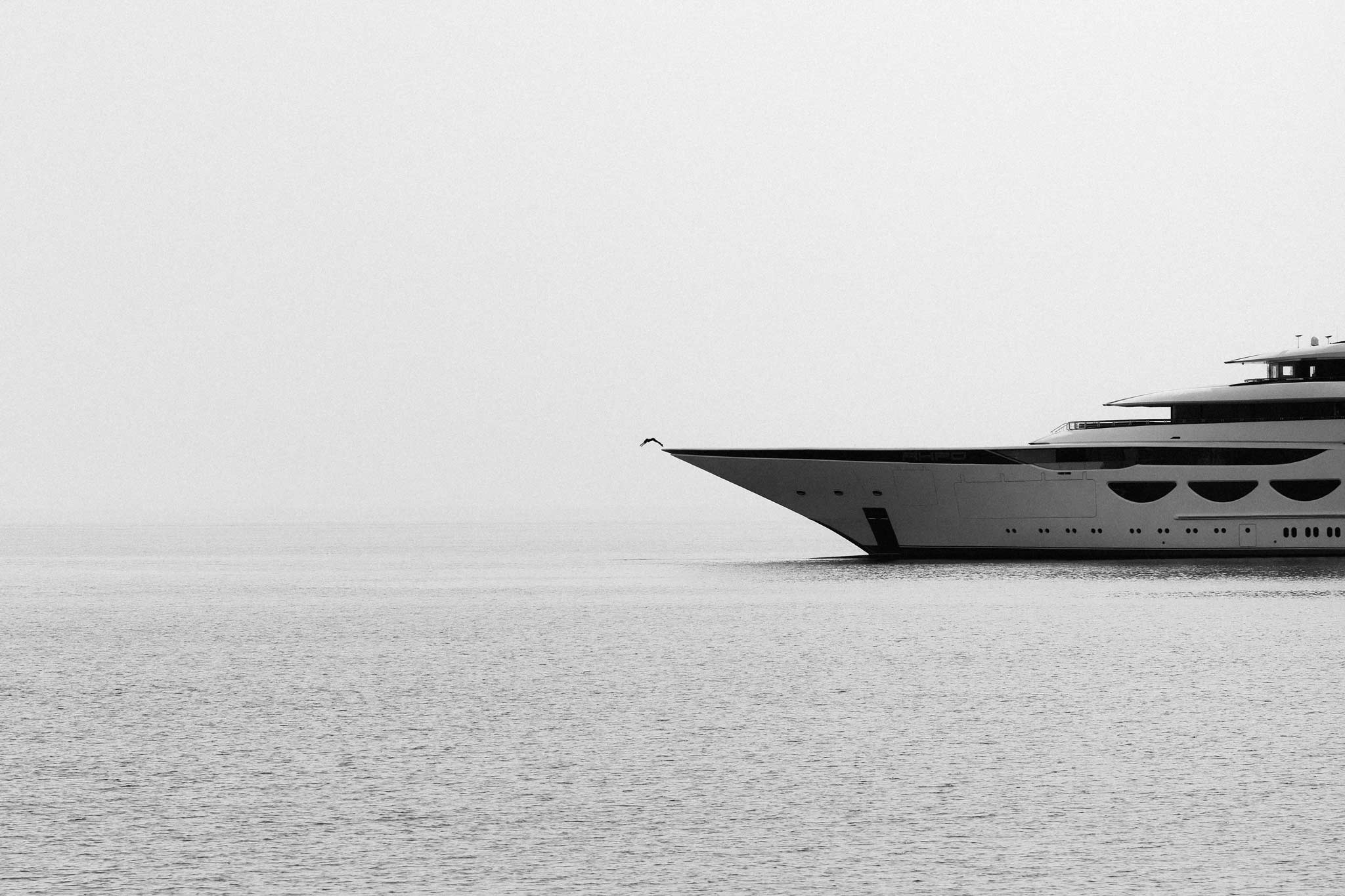 Summer Heights by Raex Murillo, black and white photograph of a diver leaping from the bow of a super-yacht into the Red Sea