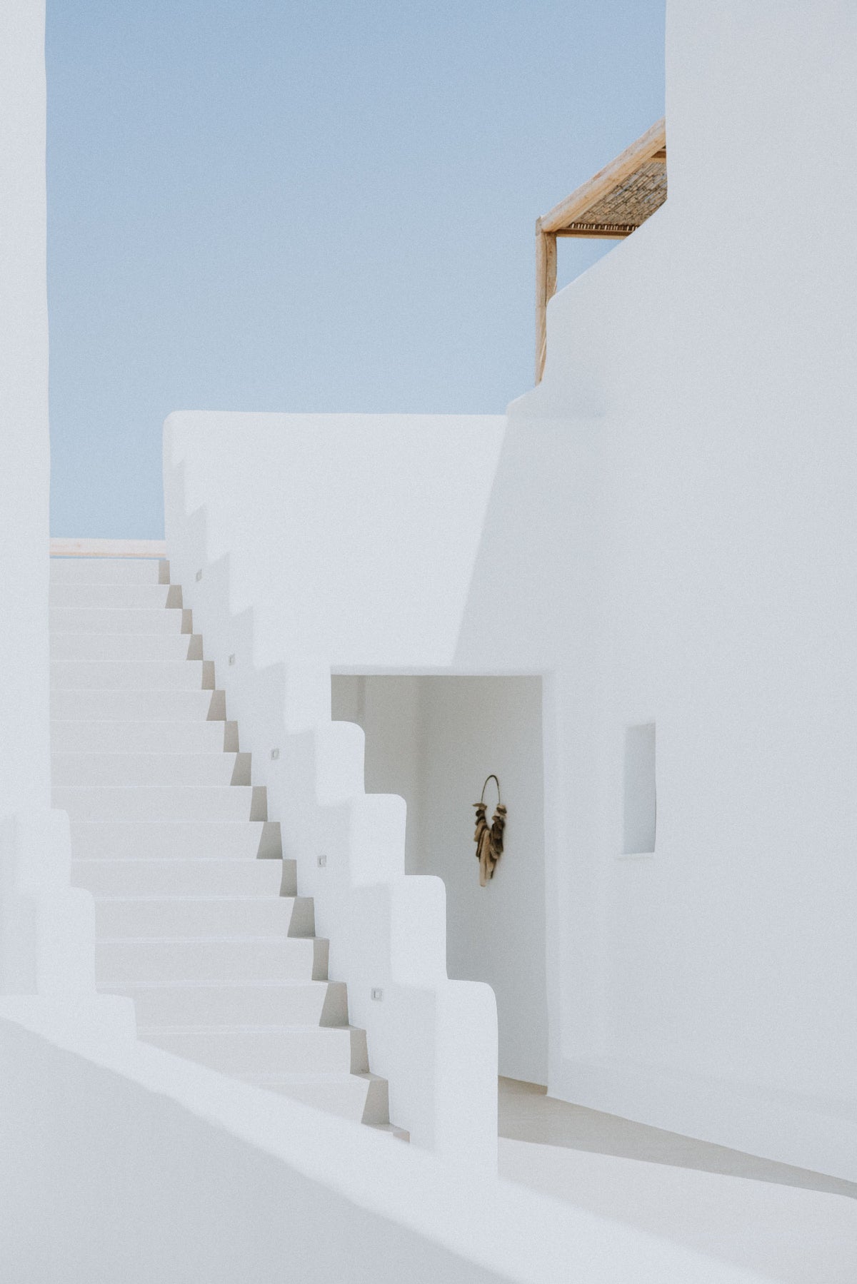White Passage by Will Salkeld, white Cycladic staircase and threshold in Paros against deep blue sky, minimalist colour photography.