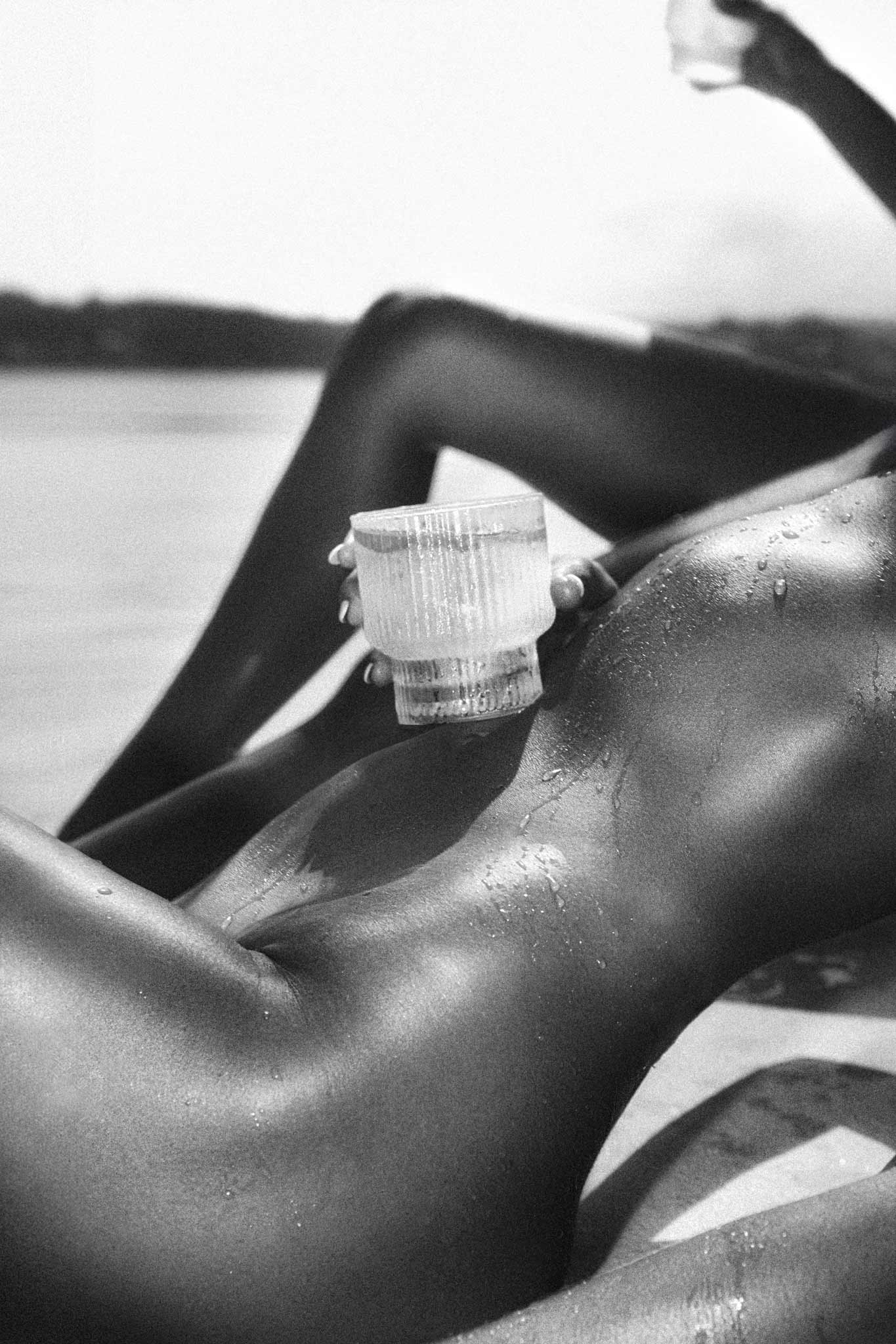 Quenched by Raex Murillo, black and white photograph of the body in stillness after heat and water with wet skin and directional light